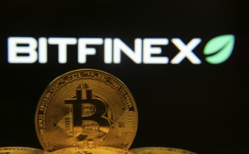 Dhaka, Bangladesh- 15 June 2025: Close-up of Bitcoin coins with the Bitfinex logo visible on a