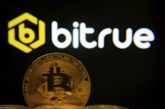 Dhaka, Bangladesh- 03 Sep 2025: Close-up of Bitcoin coins with the Bitrue logo visible on a screen