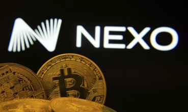 Dhaka, Bangladesh- 06 Sep 2025: Close-up of Bitcoin coins with the Nexo logo visible on a screen in