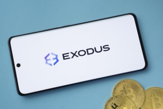 Dhaka, Bangladesh- 06 Sep 2025: Exodus logo on smartphone screen near Bitcoin coin and QR code on