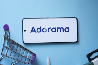 Dhaka, Bangladesh- 03 July 2025: Smartphone displaying Adorama logo with shopping cart on a blue
