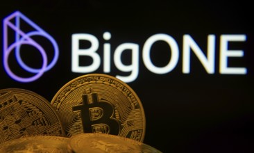 Dhaka, Bangladesh- 15 June 2025: Close-up of Bitcoin coins with the Bigone logo visible on a screen