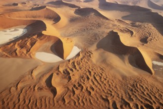 Sand dunes and dry pans in the Namib Desert. In the evening. Aerial view. Namib-Naukluft Park,