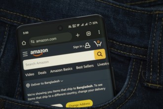 Dhaka, Bangladesh- 15 June 2025: A smartphone displaying the Amazon.com web interface peeks out of