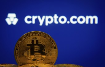 Dhaka, Bangladesh- 26 Aug 2025: Close-up of Bitcoin coins with the Crypto.com logo visible on a