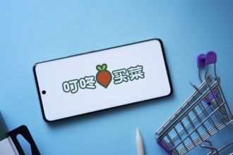 Dhaka, Bangladesh- 03 July 2025: Smartphone displaying Dingdong Maicai logo with shopping cart on a