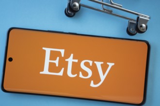 Dhaka, Bangladesh- 03 July 2025: Smartphone screen showing the Etsy logo with shopping cart wheels