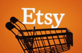 Dhaka, Bangladesh- 03 July 2025: Silhouette of a shopping cart in front of the Etsy logo,