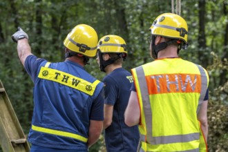 Construction of a temporary bridge over a slipped road crossing a stream, by the bridge
