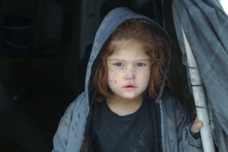 Displaced Syrian families and children living in refugee camps during harsh winter conditions,