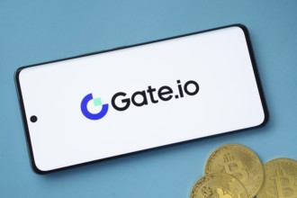Dhaka, Bangladesh- 22 June 2025: Gate.io logo on smartphone screen near Bitcoin coin and QR code on