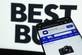 Dhaka, Bangladesh- 03 July 2025: Smartphone displaying Best Buy web interface against Best Buy logo