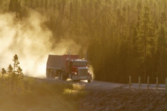 Transport truck driving on a dusty forest track, Province of Quebec, Canada, North America