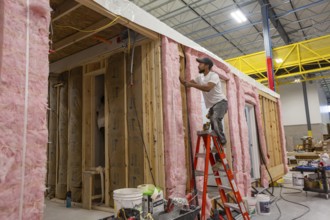 Romulus, Michigan - Workers build apartments in Ginosko Modular 's factory using modular