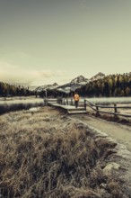 Young woman at Lake Staz near Sankt Moritz in the Engadine in Switzerland. Morning atmosphere with