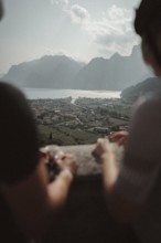 Young man taking a coffee break while riding his racing bike on Lake Garda. Sunny weather and dolce