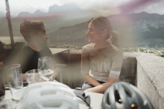 Young man taking a coffee break while riding his racing bike on Lake Garda. Sunny weather and dolce