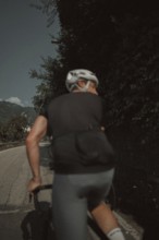 Young man riding a racing bike on Lake Garda. Sunny weather and dolce vita