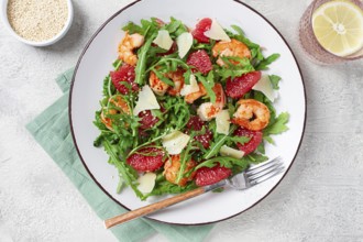Fresh shrimp salad with arugula, grapefruit, and parmesan served in a bowl