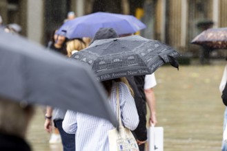 Rainy weather in Stuttgart. People with umbrellas hurry through the rain on Königstraße. Stuttgart,