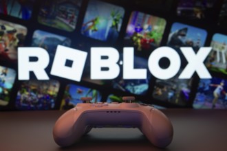 Dhaka, Bangladesh- 26 July 2025: A close-up of a white gamepad with The Roblox seen on screen in