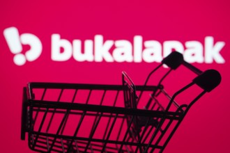 Dhaka, Bangladesh- 03 July 2025: Silhouette of a shopping cart in front of the Bukalapak logo,
