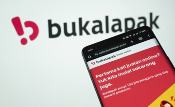 Dhaka, Bangladesh- 03 July 2025: Smartphone displaying Bukalapak web interface against Bukalapak