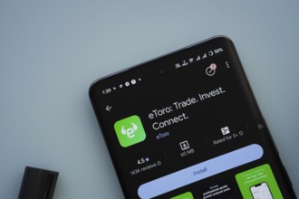 Dhaka, Bangladesh- 29 May 2025: On a blue surface, a smartphone displays the eToro app within the