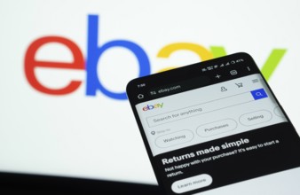 Dhaka, Bangladesh- 03 July 2025: Smartphone displaying eBay web interface against eBay logo