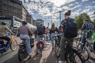 Ride your bike on the central cycle path on Lange Viestraat, Vredenburg, in the city centre of