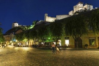 Night shot of the Peace Square in the historic centre of Trencín, Trencín Castle in the background,