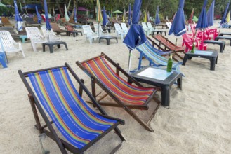 Abandoned deckchairs and parasol after sunset at Charlie Beach, Koh Mook Island, Andaman Sea,