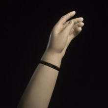 A detailed view of a mannequin hand with fingers slightly curled, creating a graceful pose against