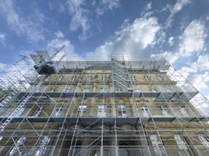 Scaffolded façade of the district court with metal platforms and stairs in Wuppertal, Germany