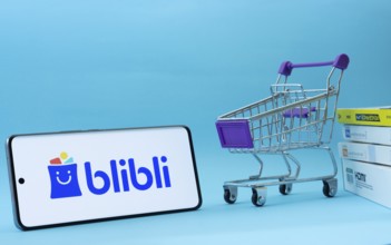 Dhaka, Bangladesh- 03 July 2025: Smartphone with Blibli logo next to a small shopping cart and