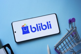 Dhaka, Bangladesh- 03 July 2025: Smartphone displaying Blibli logo with shopping cart on a blue
