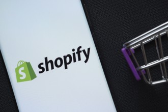 Dhaka, Bangladesh- 03 July 2025: A smartphone displaying the Shopify logo next to a miniature