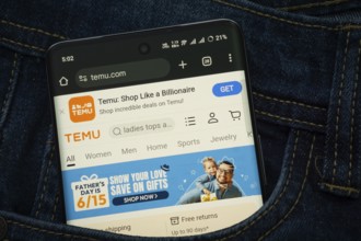 Dhaka, Bangladesh- 15 June 2025: A smartphone displaying the Temu web interface peeks out of a