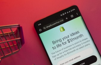 Dhaka, Bangladesh- 23 June 2025: A smartphone displaying the Shopify website with a shopping cart