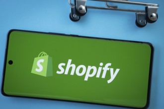 Dhaka, Bangladesh- 03 July 2025: Smartphone screen showing the Shopify logo with shopping cart
