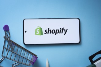 Dhaka, Bangladesh- 03 July 2025: Smartphone displaying Shopify logo with shopping cart on a blue