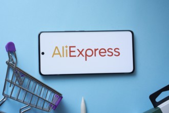 Dhaka, Bangladesh- 03 July 2025: Smartphone displaying AliExpress logo with shopping cart on a blue