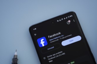 Dhaka, Bangladesh- 29 May 2025: On a blue surface, a smartphone displays the Facebook app within