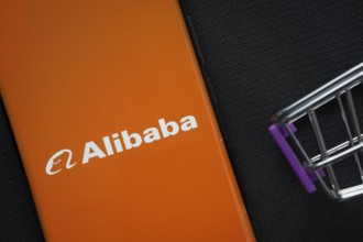 Dhaka, Bangladesh- 03 July 2025: A smartphone displaying the Alibaba logo next to a miniature