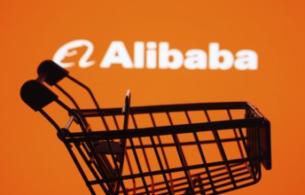 Dhaka, Bangladesh- 03 July 2025: Silhouette of a shopping cart in front of the Alibaba logo,