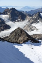 At the Wilder Freiger summit, picturesque high mountain landscape with snow, view of the