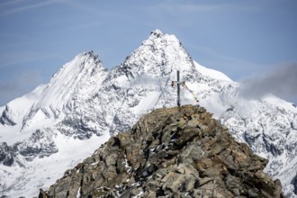 Summit cross of the summit Böses Weibl, behind summit of the Großglockner with snow, Schober group,