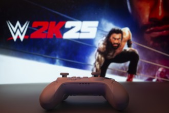 Dhaka, Bangladesh- 03 July 2025: A close-up of a white gamepad with The WWE 2K25 seen on screen in