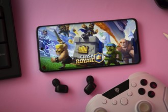 Dhaka, Bangladesh- 15 July 2025: A close-up of a gamepad with the Clash Royale seen on smartphone