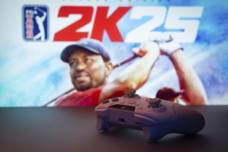 Dhaka, Bangladesh- 03 July 2025: A close-up of a white gamepad with The PGA TOUR 2K25 seen on